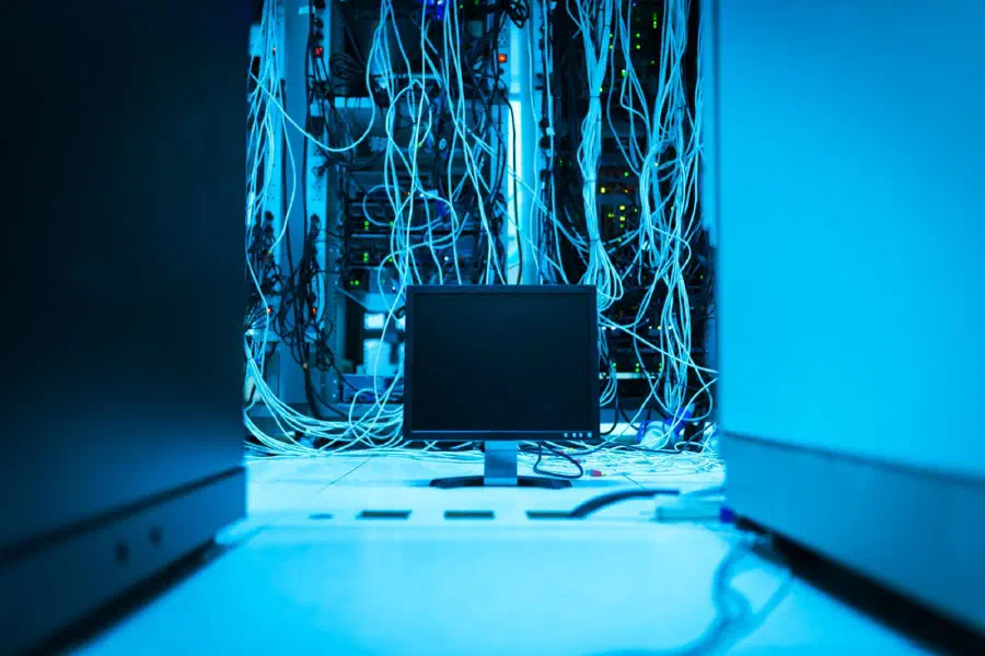 Server racks and network cabling in a data centre aisle